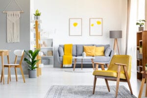 Yellow,Armchair,On,Rug,Near,Plant,In,Open,Space,Interior