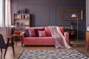 Pastel,Pink,Blanket,On,A,Matching,Sofa,In,Living,Room